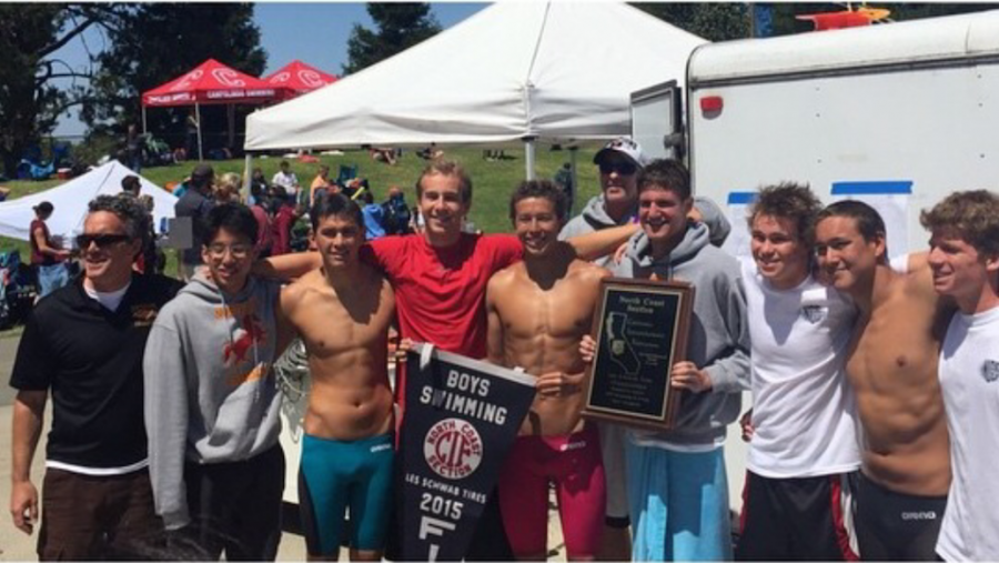 Coach Tommy Ortega stands with swimmers (from left) Stanley Wu, Calvin Kirkpatrick, Jace Cropper, Mason Tittle, Max Bottine, Philip Stahl, Eric Van Brocklin, and Tate Lloyd with the NCS plaque