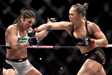 RIO DE JANEIRO, BRAZIL - AUGUST 01: Ronda Rousey of the United States punches Bethe Correia of Brazil in their bantamweight title fight during the UFC 190 Rousey v Correia at HSBC Arena on August 1, 2015 in Rio de Janeiro, Brazil. (Photo by Buda Mendes/Zuffa LLC/Zuffa LLC via Getty Images)