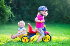 stock-photo-47921332-two-kids-on-a-bike-in-the-garden