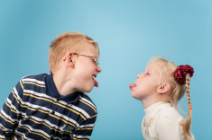 stock-photo-48841938-teenage-boy-and-girl-stick-out-tongues-to-each-other