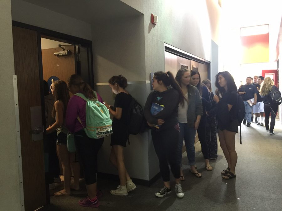 Girls wait in line to use the bathroom during brunch in early September. Some students say the tardy policy is impacting their use of the restrooms.