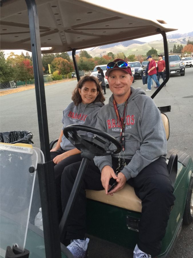 Jennifer Paynton and new athletic director Dr. Earle Paynton ride around in a Northgate golf cart during a home football game on November 4.