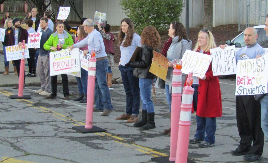 Teachers greet parents Jan. 13 at the drop off zone to oppose the formation of a new district that includes Northgate, holding signs and handing out flyers.