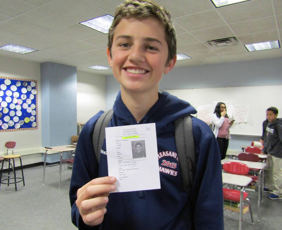 Freshman Anthony Giannini receives a pass with photo to leave his English class in February