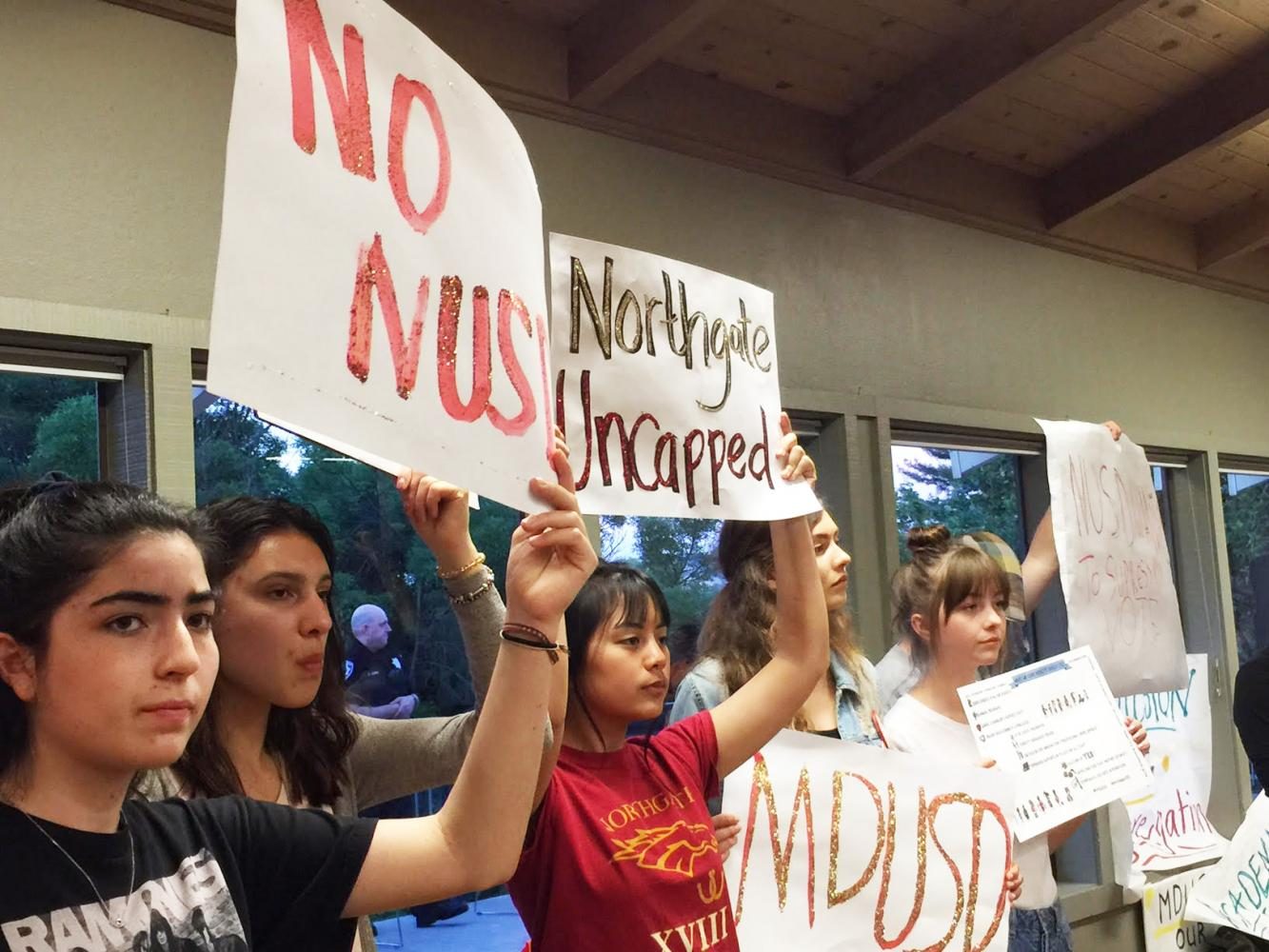 Sophomore Aava Farhadi, sophomore Ellora Easton, junior Allyson Tayao, junior Annika Olson, junior Mackenzie Champion, and senior PJ Gaughan raise signs of No NUSD and Northgate Uncapped to voice their opposition to NUSD on May 4.