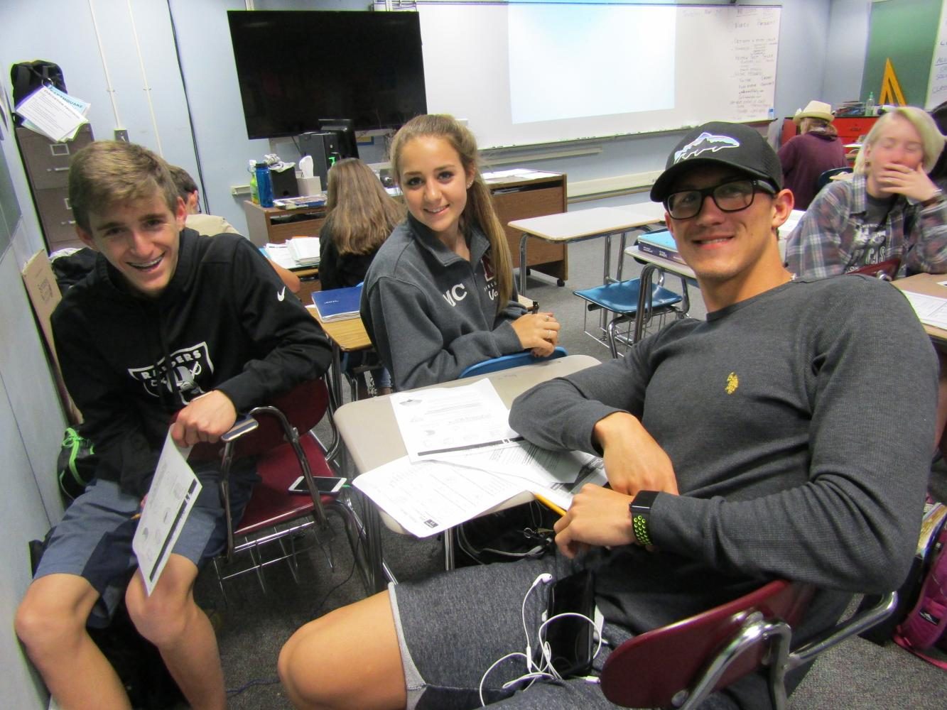 Sophomores Ryan Crostwaite and Maddie Chappell study in math on May 25 with junior Alexei Sancov, an Olympian who set several records.