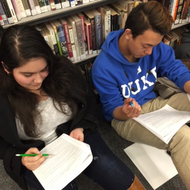 Seniors Helen Astoria and Darrien Ward review senate bills of their “colleagues” in preparation of Mock Congress Dec. 7 and 8.
