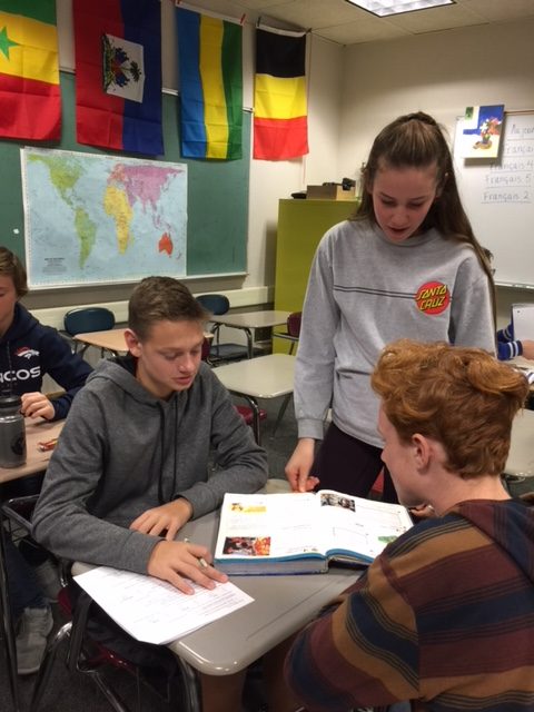 Maddy Gossett, a junior and mentor, looks on as freshmen James Park, left, and Jackson Cooper work in their Link Crew class during Study Session Dec. 18.