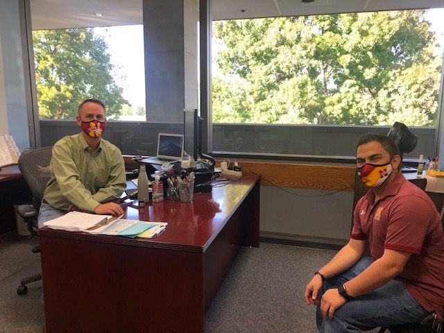 Vice Principal Craig Bocks, left, meets with Assistant Athletic Director Brandon Enriquez Oct. 29.