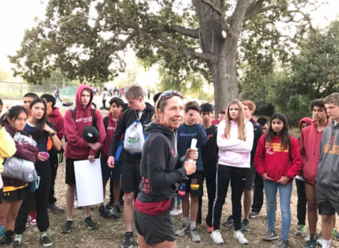 Coach Ruth Seabrook (center) gives advice to her runners during the 2019 season before they begin their training.