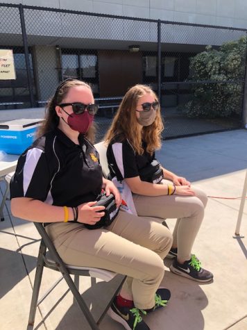 Seniors Jamie Champion, left, and Amanda Dahlgren attend water polo games April 17 as members of their Sports Medicine program where students trainers are assigned to each school athletic team in case of injury or medical need.
