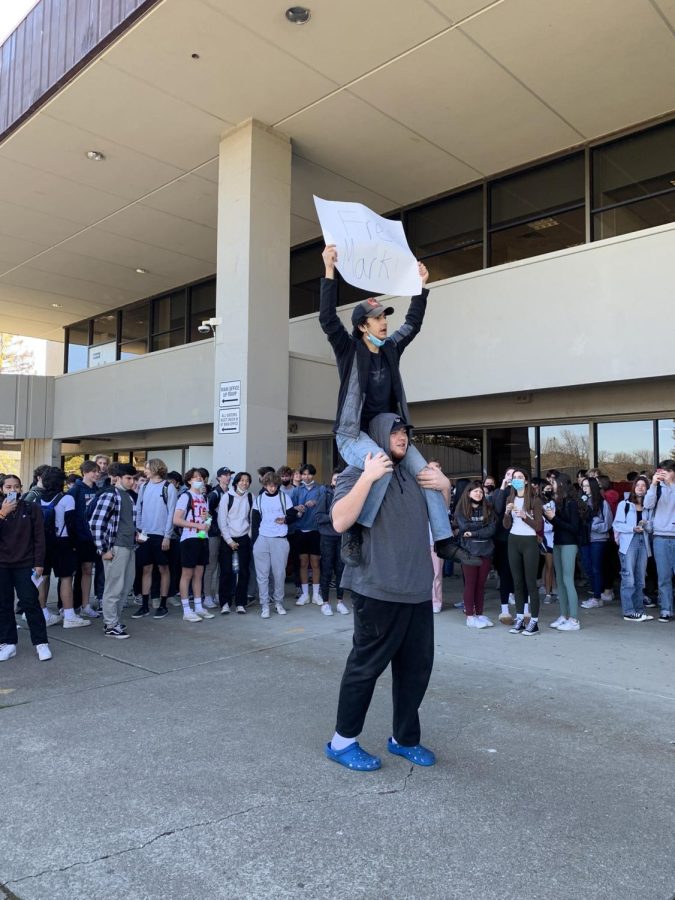 Seniors Erfan Moradi (above) and John Rigau (below) demonstrate at a March 11 rally with the slogan Free Mark, organized to bring attention to their disappointment in the departure of a campus supervisor.