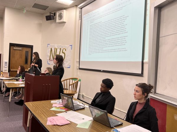 Seniors participating in Mock Congress on Dec. 6 include President Pro Tem Eva Kroz at the podium and Senate Leaders Noobah Vonan and Teresa Etcheveste, with social studies teachee Paula Dillon standing in the far backround and social studies teacher Christine Reimer seated.  
