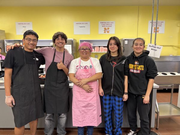 (From left to right, senior Ramon Iniguez, senior Ethan Parks, cafeteria manager Shelley Carmichael, junior Minna Hill, and junior Nadia Hill take a break after serving up hundreds of lunches on a busy day in November.