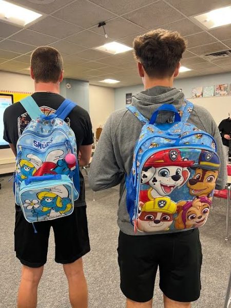 Seniors Damon Oberbruner and Tyler summers sport some of their childhood favorites - the Smurfs and the Paw Patrols - for their senior year backpacks.