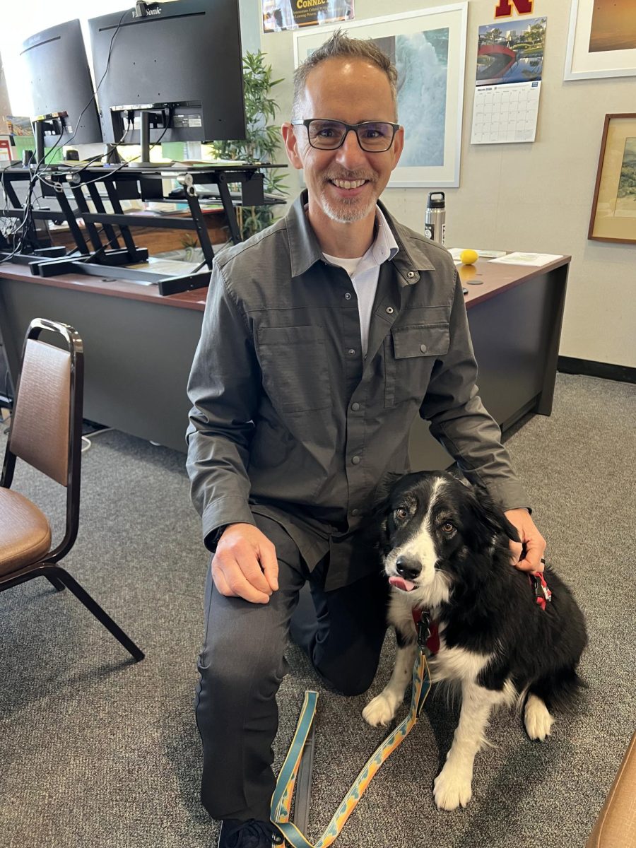 Rocky, seen here with his human, Vice Principal Tucker Farrar, is one of five cute dogs spending this year at school.